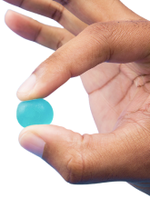 Hand holding a blue gummy
